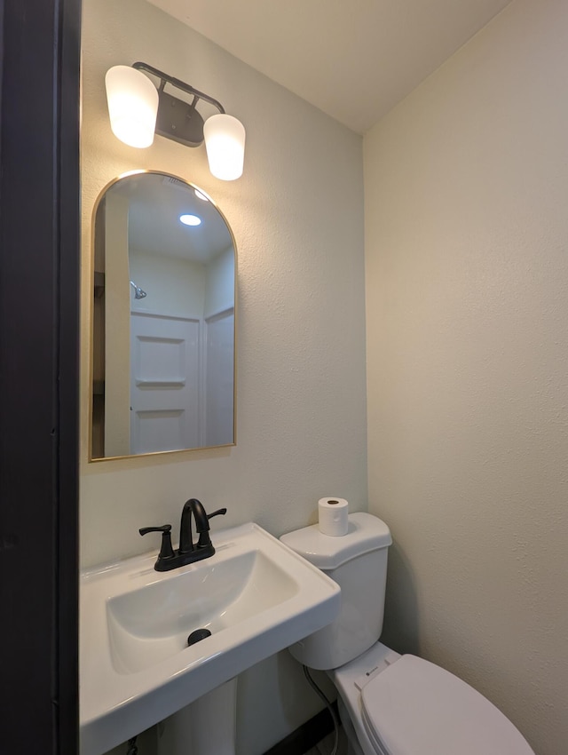 bathroom featuring sink and toilet