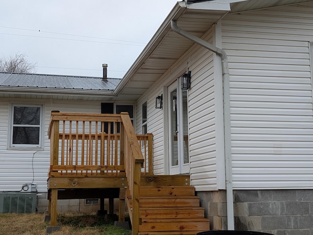 exterior space featuring central AC unit and a wooden deck