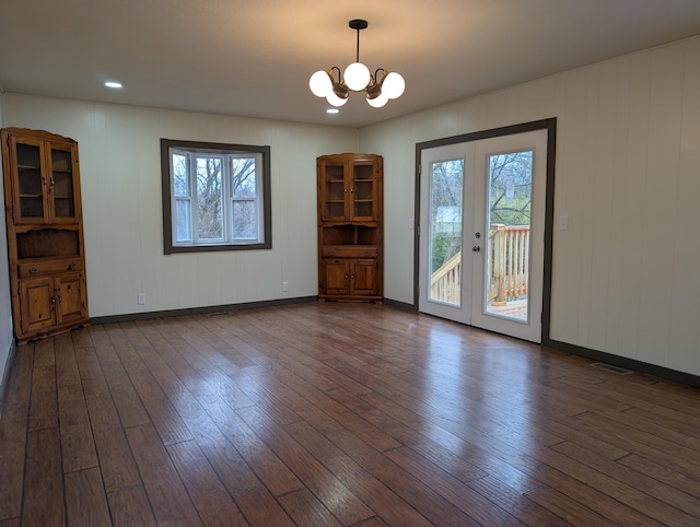 interior space featuring dark wood-type flooring, a notable chandelier, and french doors