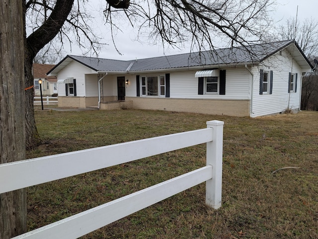 ranch-style home with a front lawn