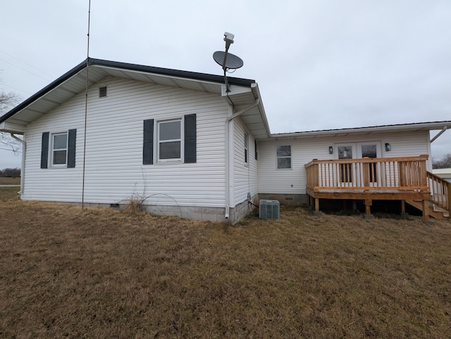 rear view of property featuring a wooden deck, a yard, and central AC unit