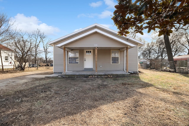 bungalow-style house featuring a front lawn and covered porch