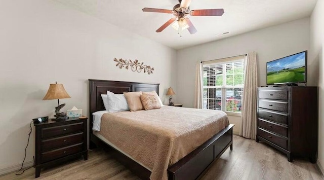 bedroom featuring hardwood / wood-style flooring and ceiling fan