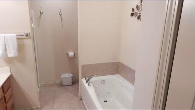 bathroom featuring vanity, tile patterned flooring, and a washtub