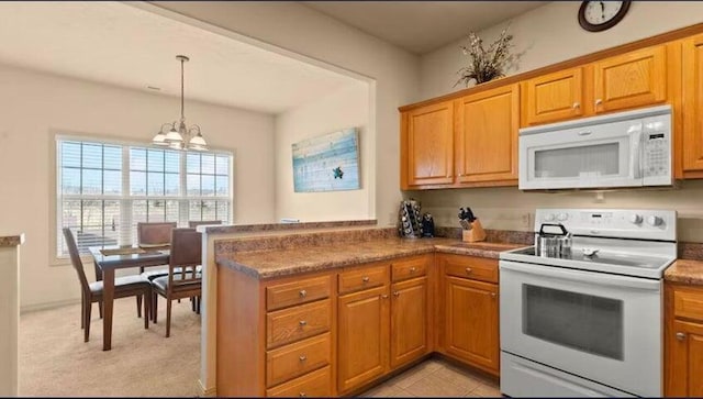 kitchen with pendant lighting, white appliances, an inviting chandelier, light carpet, and kitchen peninsula