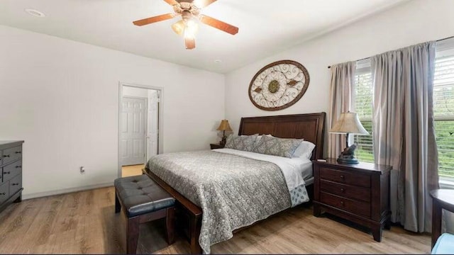 bedroom with ceiling fan and light wood-type flooring