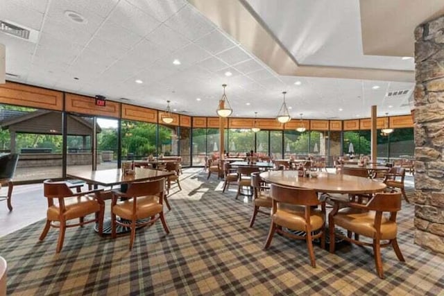 carpeted dining room with floor to ceiling windows