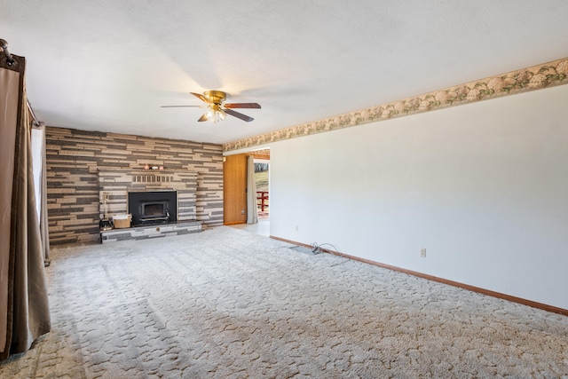 unfurnished living room featuring carpet flooring, a textured ceiling, and ceiling fan