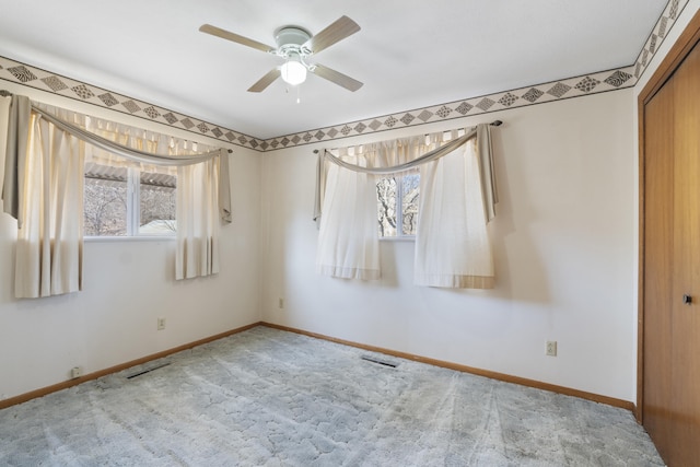 carpeted empty room with ceiling fan