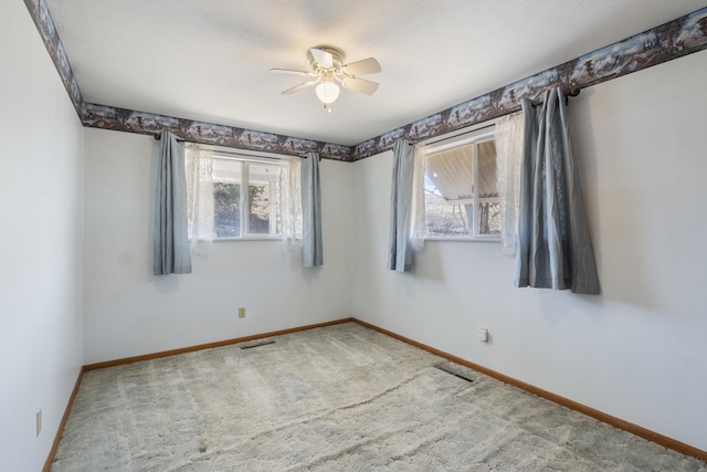 unfurnished room featuring ceiling fan and carpet