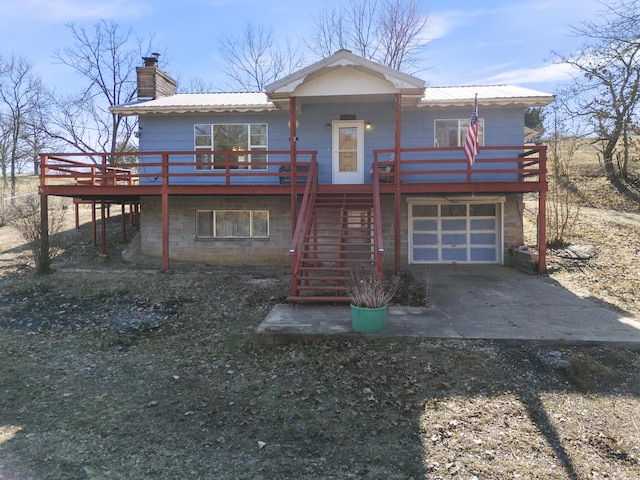 view of front of property with a wooden deck and a garage