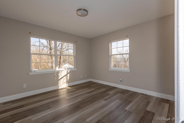 empty room with dark hardwood / wood-style floors