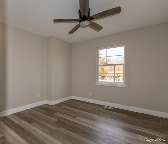 empty room with hardwood / wood-style floors and ceiling fan