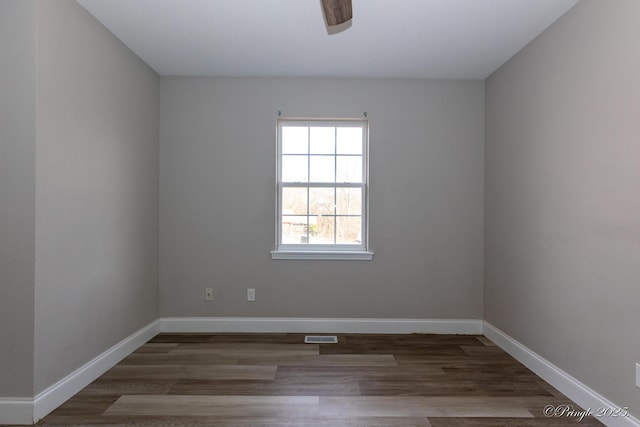 unfurnished room featuring ceiling fan and dark hardwood / wood-style flooring