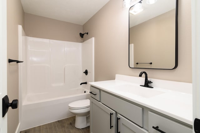 full bathroom with vanity, shower / bathing tub combination, hardwood / wood-style floors, and toilet