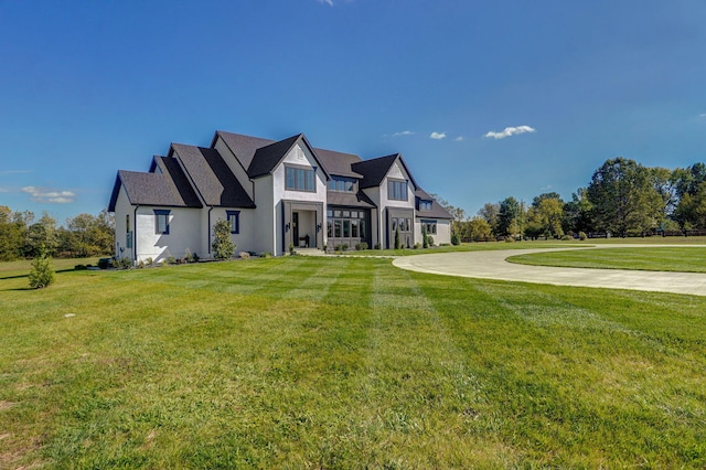 english style home with a front lawn