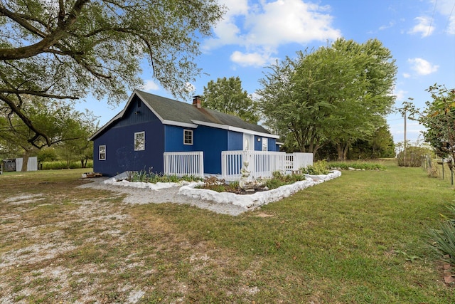 view of side of home with a lawn