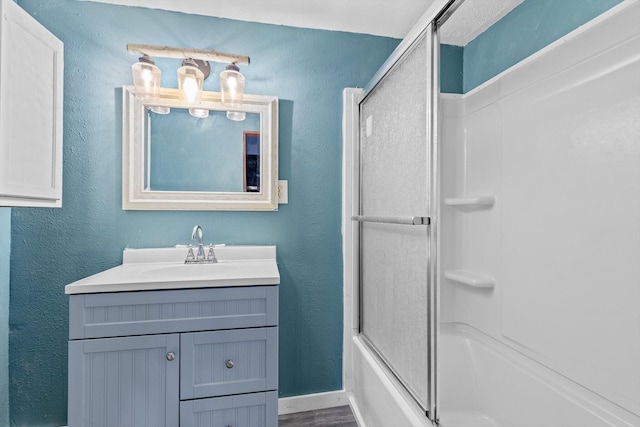 bathroom with enclosed tub / shower combo and vanity