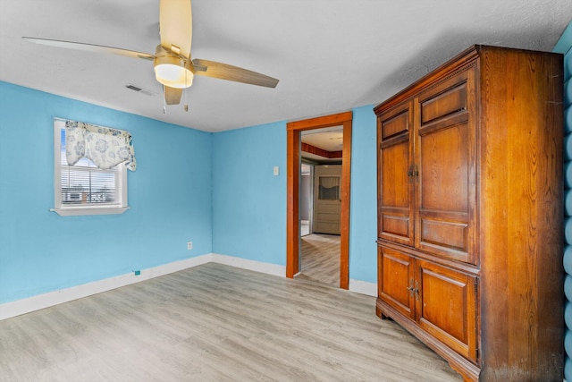 unfurnished bedroom featuring ceiling fan and light hardwood / wood-style flooring