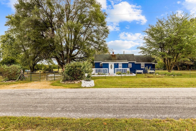 single story home with a front lawn and covered porch