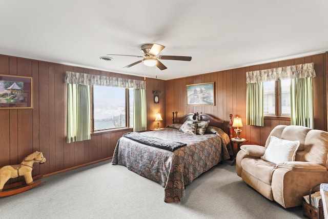 carpeted bedroom featuring multiple windows and ceiling fan