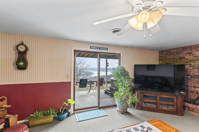 carpeted living room with ceiling fan