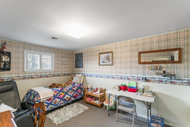 bedroom with wainscoting, carpet flooring, visible vents, and wallpapered walls