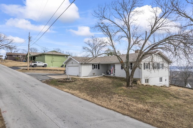 view of front of property with a garage and a front lawn