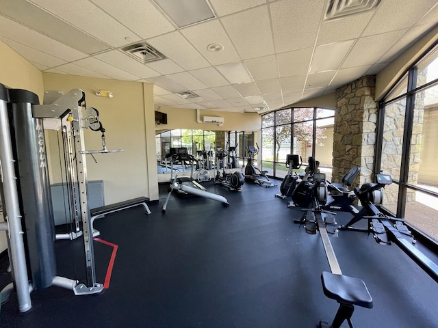 workout area with visible vents and a drop ceiling