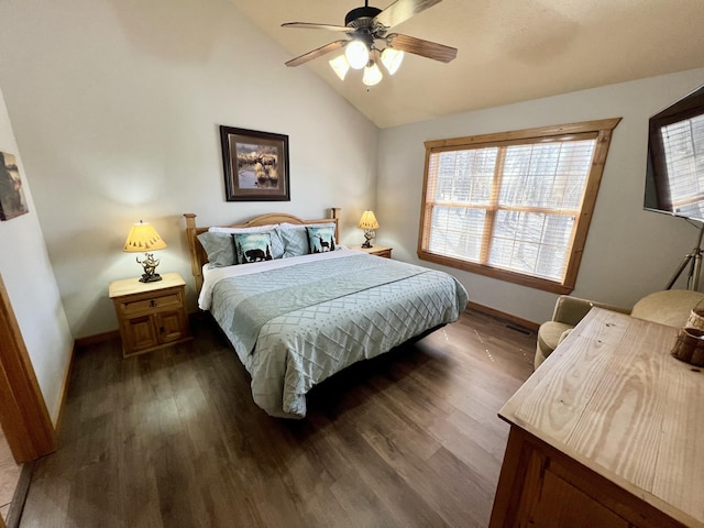 bedroom with lofted ceiling, baseboards, and dark wood-type flooring