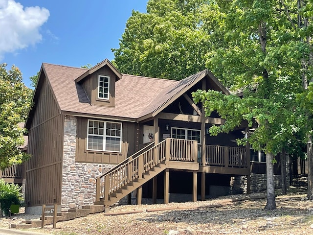 84 Bells Ave, Branson West, MO 65737 - view of front of property with stone siding, roof with shingles, a deck, and stairs