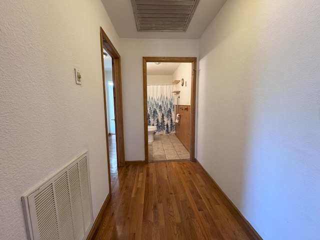 corridor featuring hardwood / wood-style floors