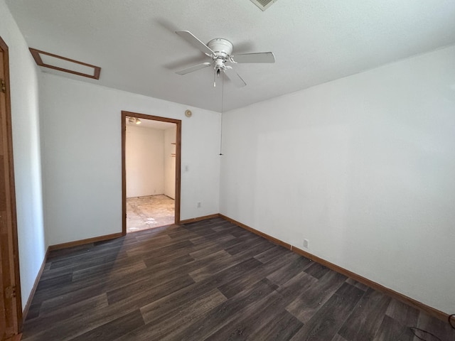 spare room featuring dark hardwood / wood-style flooring and ceiling fan