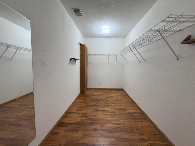 walk in closet featuring dark hardwood / wood-style flooring