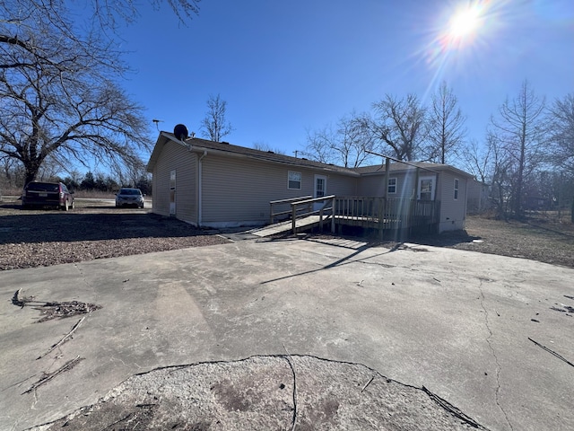 rear view of property with a wooden deck