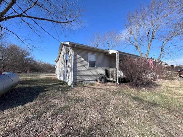 view of side of home with a lawn