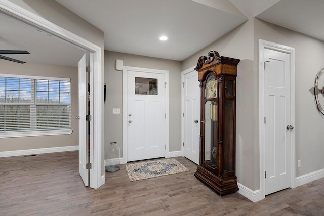 foyer entrance with hardwood / wood-style floors and ceiling fan