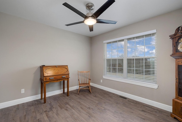 living area with ceiling fan and hardwood / wood-style floors