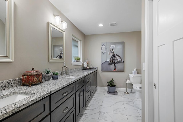 bathroom featuring vanity and toilet