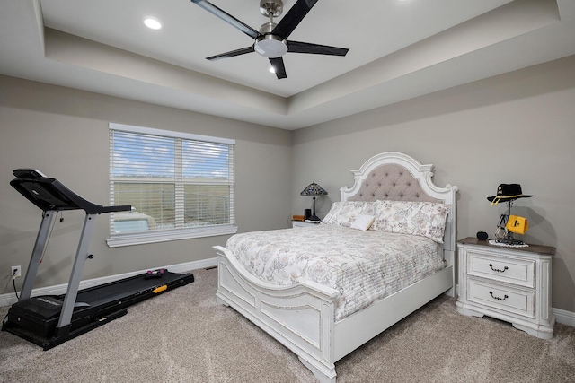 bedroom with ceiling fan, a raised ceiling, and carpet