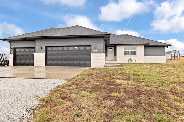 prairie-style house featuring a garage and a front lawn