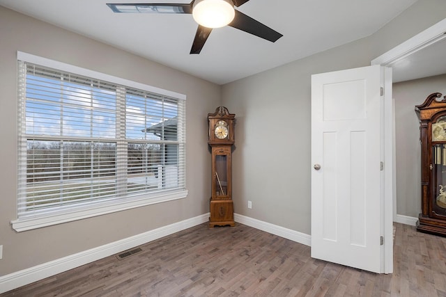 unfurnished room with ceiling fan and light wood-type flooring