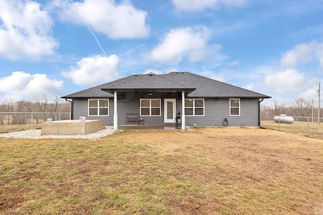 rear view of house with a yard