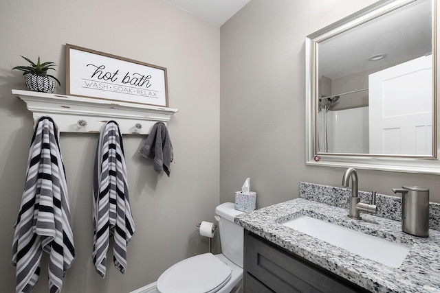 bathroom with walk in shower, vanity, and toilet