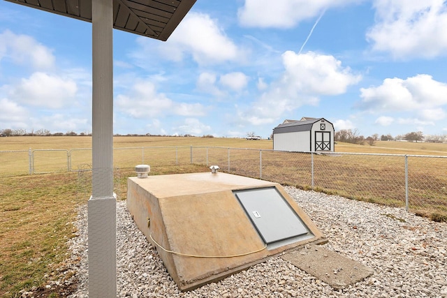 entry to storm shelter featuring a rural view and a storage unit