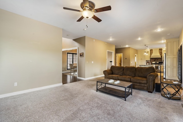 living room with ceiling fan and light colored carpet