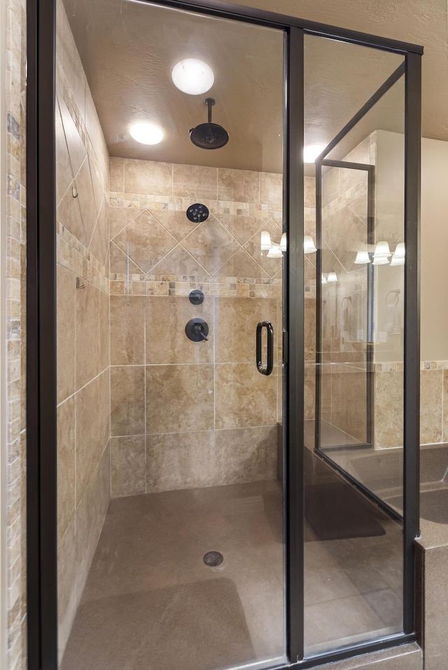 bathroom featuring a shower with shower door