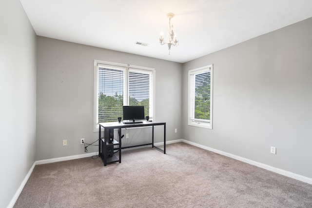 home office with a chandelier and carpet