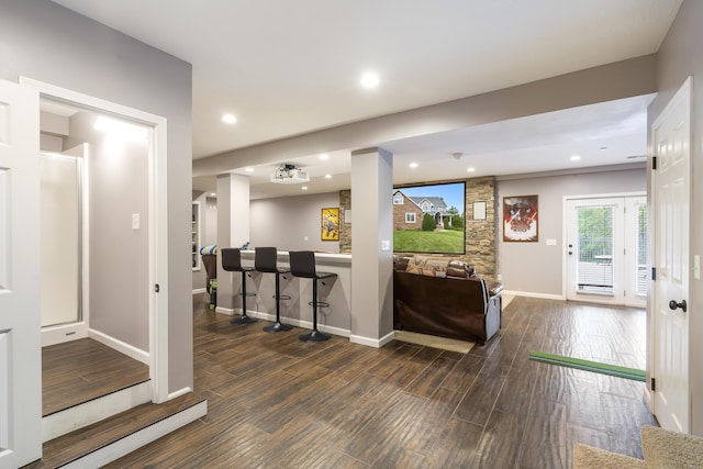 interior space featuring dark wood-type flooring and bar area