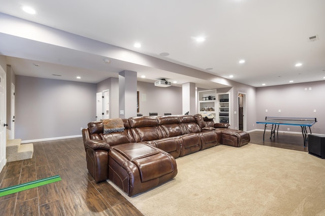 home theater with hardwood / wood-style flooring and built in features